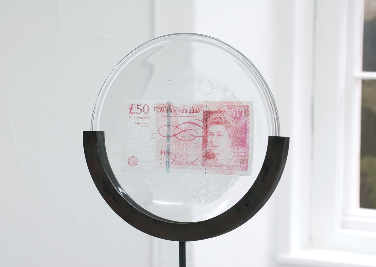 David Blackmore: Detail of £105,048.65: £50 Sterling banknote fused by bleach on to an IKEA plate on mild steel armature